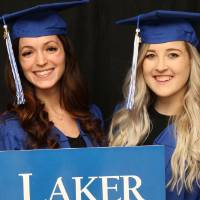 GradFest attendees hold up laker sign together